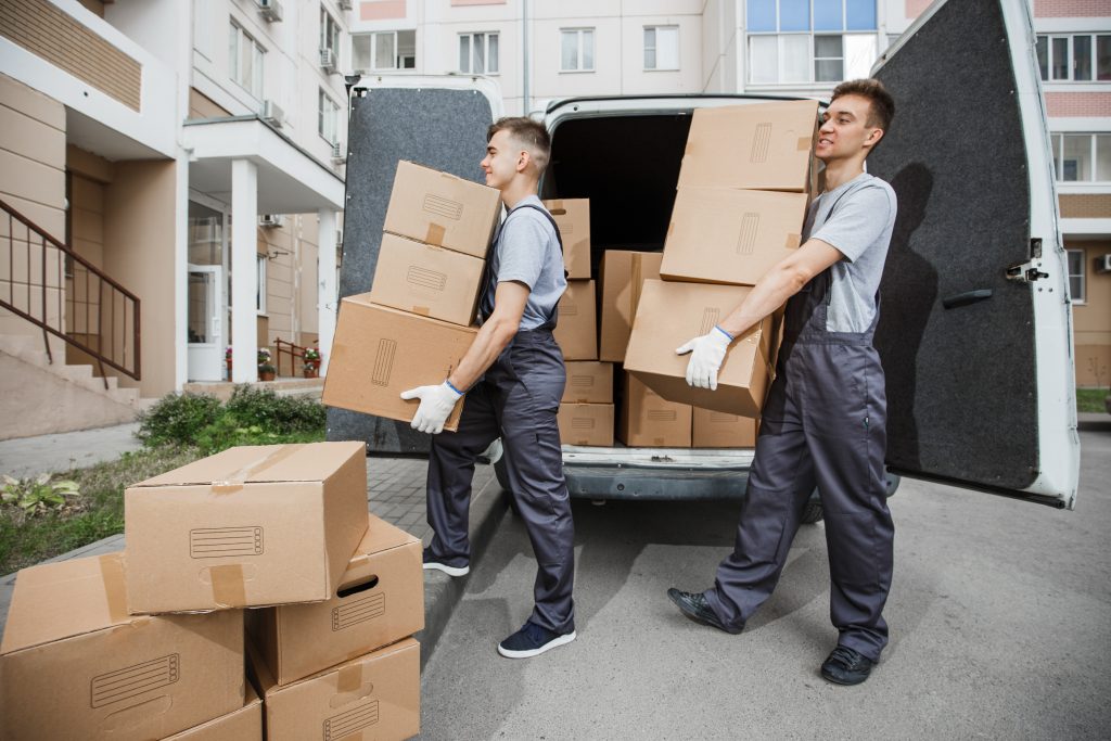 Man and Van service by Movevan moving packaged boxes out of the Van.